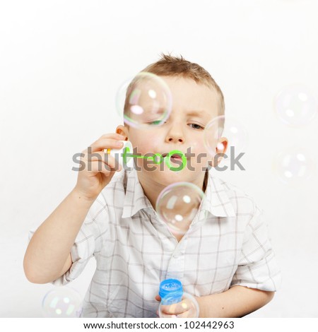 The boy lets go soap bubbles.