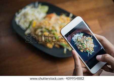 Woman hands taking food photo by mobile phone