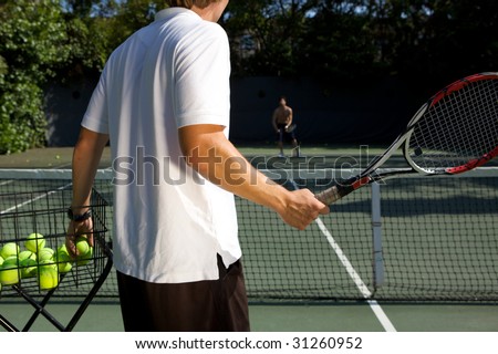 Tennis Instructor Teaching His Student