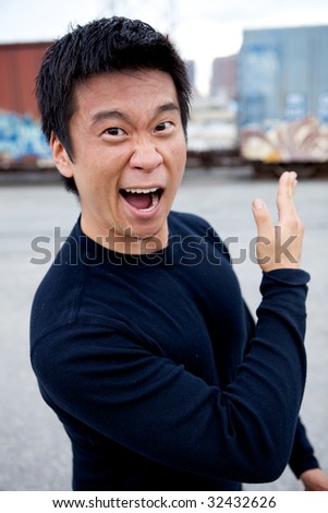 An angry asian man performing karate moves toward the camera