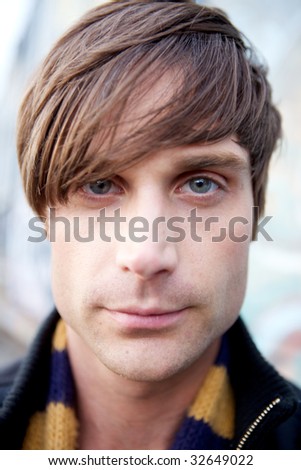 A Close-Up of a young attractive artist type with a scarf and cool haircut
