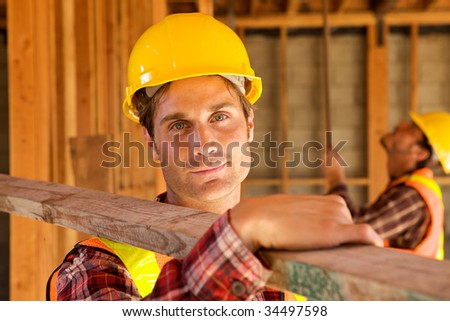 A closeup of a construction worker with a hard hat