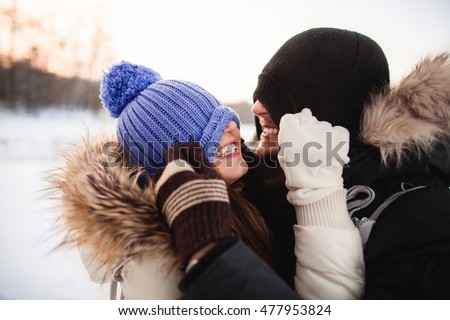 Young  happy smiling couple in love. Having fun. Winter
