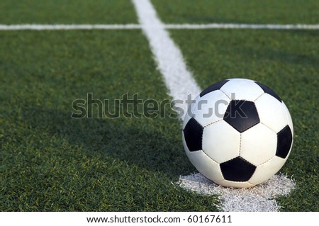 Soccer ball in the center of the field of a stadium