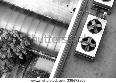 High view rooftop of the buildings, focus on air conditioner box (black and white)