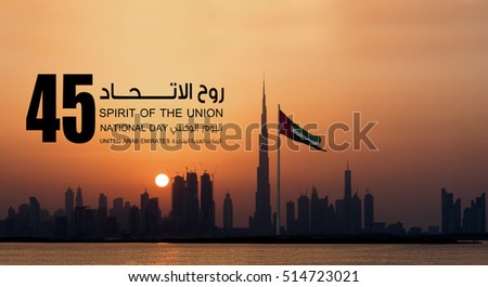United Arab Emirates national flag and Dubai skyline view during evening.