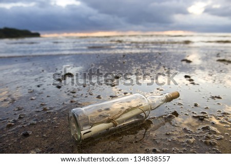 a clear glass bottle washed up on the beach, with a note inside