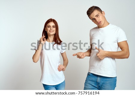 logo, white t-shirts on a young couple on a light background, free place