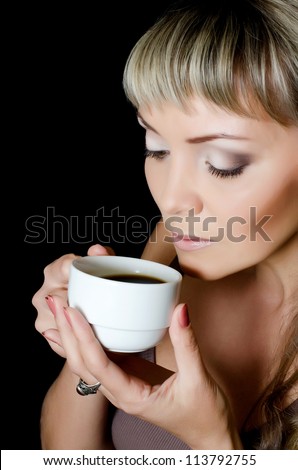 The beautiful elegant woman with coffee cup