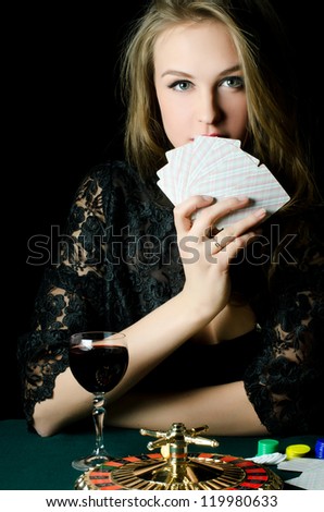 The beautiful girl with a playing card