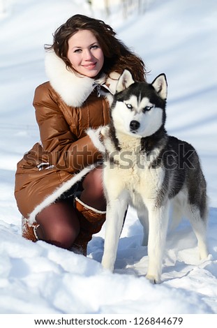 Woman with dog Husky in the winter