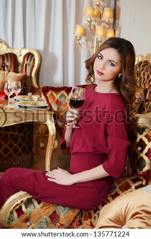 The elegant woman with wine glass at smart restaurant