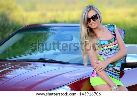 Beautiful girl stands near to white car