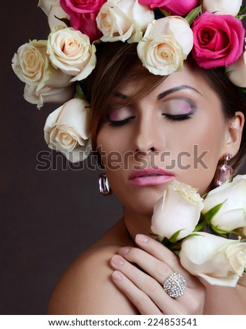 portrait of the  brunette woman with pink flowers in hair