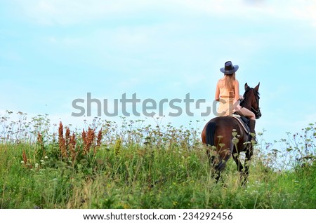 The woman on a horse in field