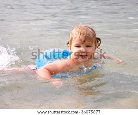 little girl swimming in river