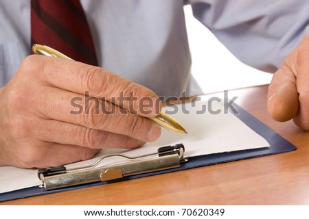 The businessman fills the document