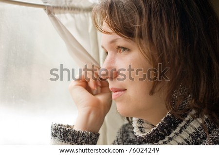 Girl in train looks out of window
