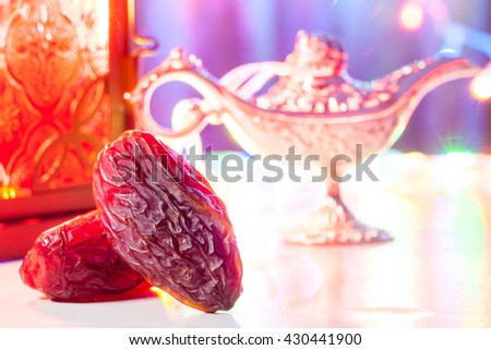 Date fruits in colorful background with Aladdin\'s lantern. Ramadan, Eid concept