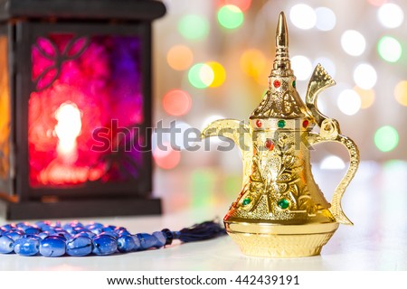 Arabic Coffee pot,Muslim prayer beads and lantern with colorful out of focus light as background. Ramadan, Eid concept