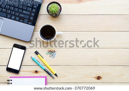 Office desk table with laptop,smartphone, coffee cup ,pen,pencil and notebook.Top view with copy space