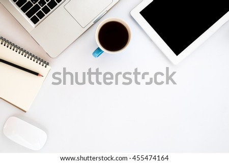 White office workspace with blank screen tablet,laptop,leather notebook,pencil,mouse and cup of coffee. Top view with copy space.Office supplies and gadgets on workspace.Working desk table concept.