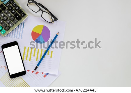 White office desk table with blank screen smartphone , chart or analysis chart, glasses, calculator and pencil. Top view with copy space.Office desk table concept.