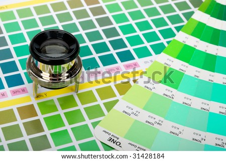 Lupe and a color guide on printed color chart (green, lime and yellow)