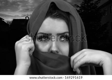 Woman escape into the night covering face