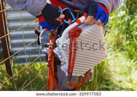 telecommunication transmitter. \
telecommunication equipment in the hands of the industrial climber