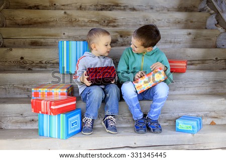 children exchanging gifts. two little brothers lovingly exchange gifts