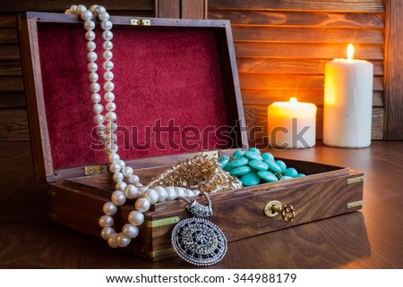 Beads in wood box on a table. Open Treasure Chest