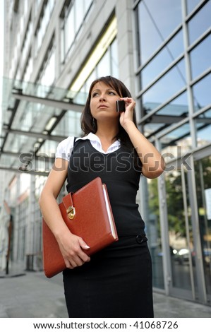 Woman. Leaving the work. In a shopping center. telephone conversation