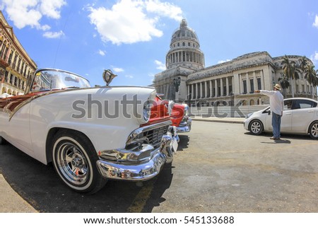 Classic old American car in front of El Capitolio. Classic cars are still in use in Cuba and old timers have become an iconic view and a worldwide known attraction.