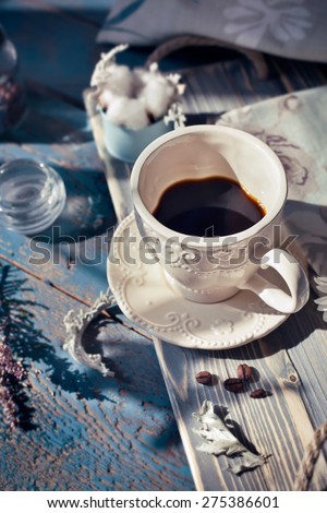 Cup of espresso set on a wooden table, natural light setting, toned photo