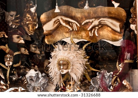 Venice shop window: masks and a copy of the detail of The Creation of Adam by Michelangelo (hands)