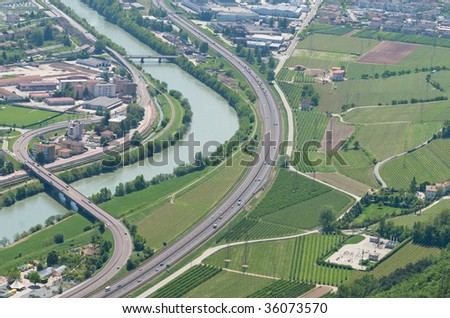 Overview of Trento, italian town with its infrastructure, the river Adige and highway