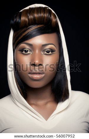 Beautiful girl with creative golden makeup, wearing a hooded dress
