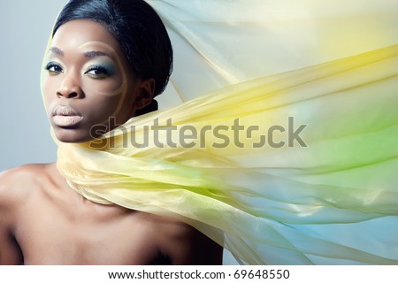 Beautiful fashion model with a silk scarf, flying on the wind
