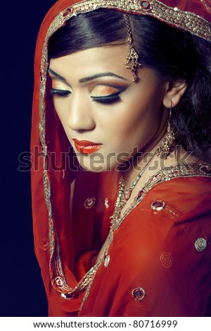  of a young indian woman in traditional clothes with bridal makeup
