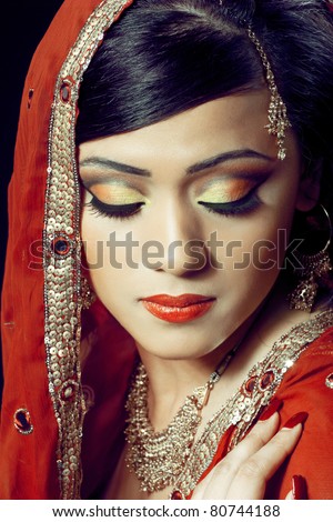  of a young indian woman in traditional clothing with bridal makeup