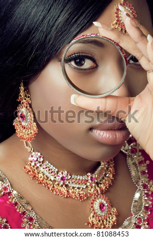 stock photo Young indian woman in traditional clothes with golden bridal 