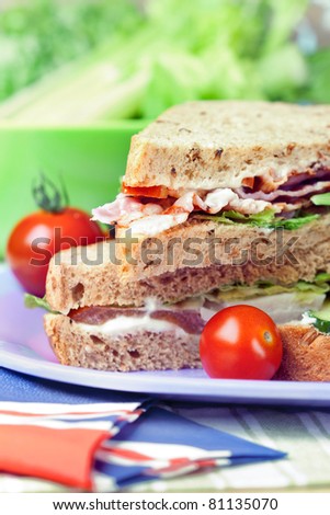 Sandwiches with bacon, chicken, lettuce and tomato with malted bread, close-up shot