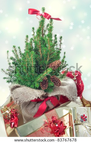 Christmas presents under the Christmas tree, on snowy background with snowflakes