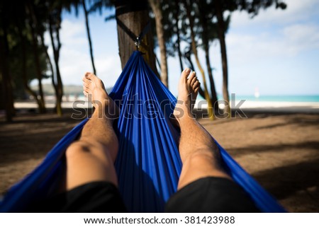 Man Laying in Hammock at Woodline on the Beach