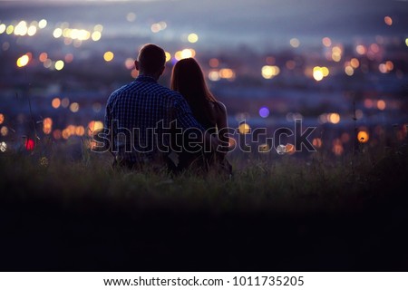Lovers man and girl against background night city, night starry sky and horizon. Concept date Valentine\'s Day, first kiss love, forever together.