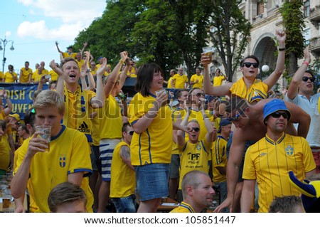 KIEV, UKRAINE - JUNE 19: Swedish football fans relax in the official fan zone of EURO-2012 in the center of Kiev, June 2012. EURO 2012 is a European football championship held by UEFA.