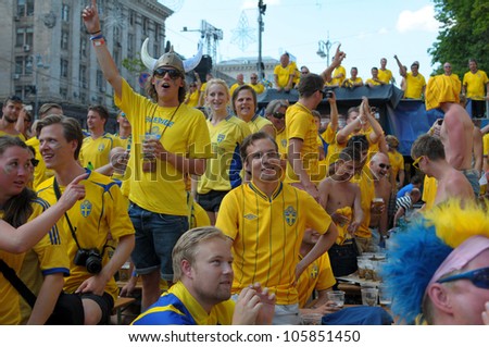 KIEV, UKRAINE - JUNE 19: Swedish football fans relax in the official fan zone of EURO-2012 in the center of Kiev, June 2012. EURO 2012 is a European football championship held by UEFA.
