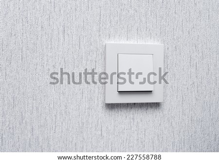 Light switch / White light switch on white wall / Concept / On Off