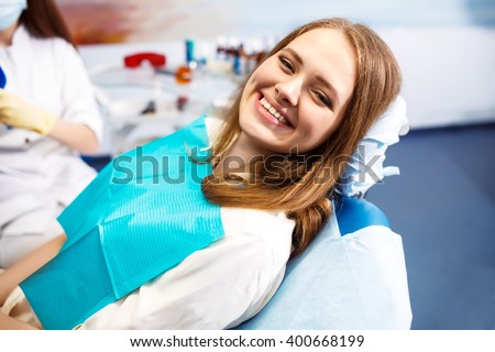 Overview of dental caries prevention.Woman at the dentist\'s chair during a dental procedure. Beautiful Woman smile close up. Healthy Smile. Beautiful Female Smile